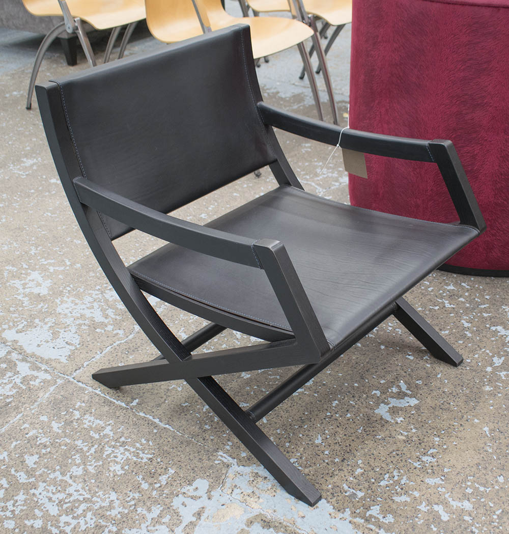 ARMCHAIR BY FLEXFORM, in black leather on an ebonised X framed base, 60cm W.