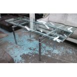 DINING TABLE, extending with glass top on chromed metal frame Norman Foster style,