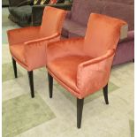 PARIS ARMCHAIRS, a pair, in burnished red on square ebonised supports, 59cm W.