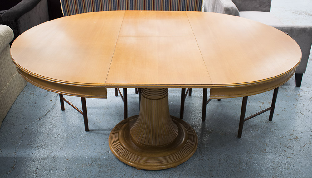 EXTENDING DINING TABLE, with internal leaf, oval on heavily carved central stand,