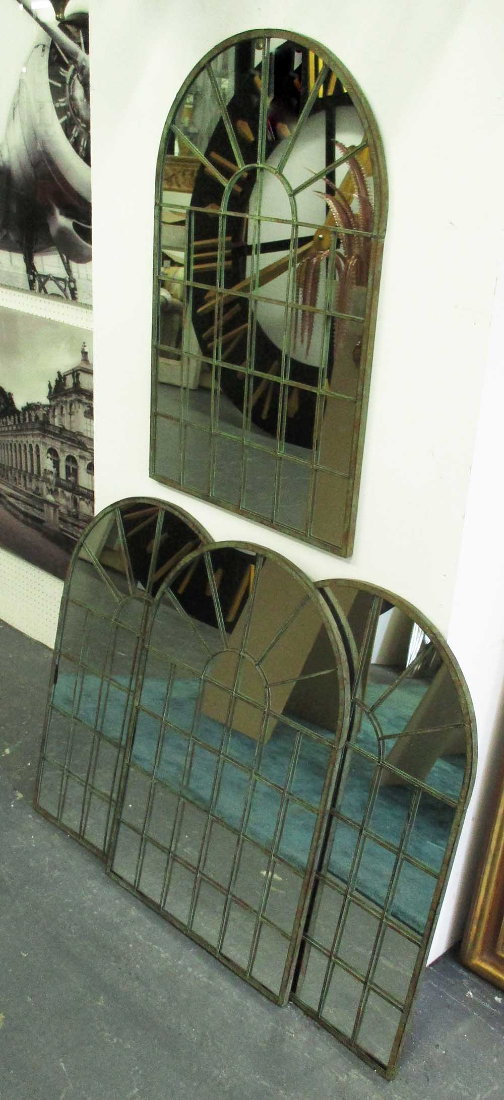ARCHITECTURAL MIRRORS, a set of four, domed top in a metal frame, 77cm x 49cm.