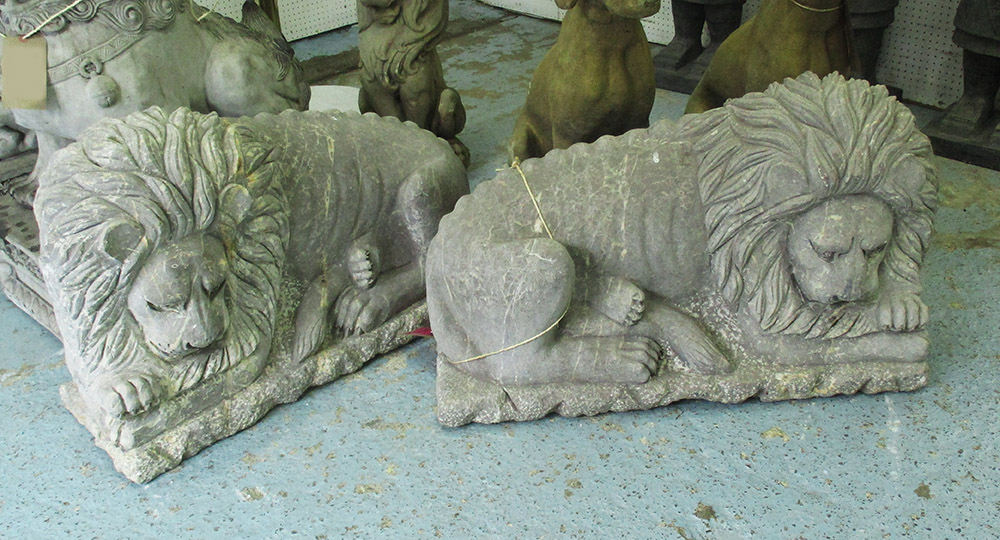 RECUMBENT LIONS, a pair, in stone, 81cm L.