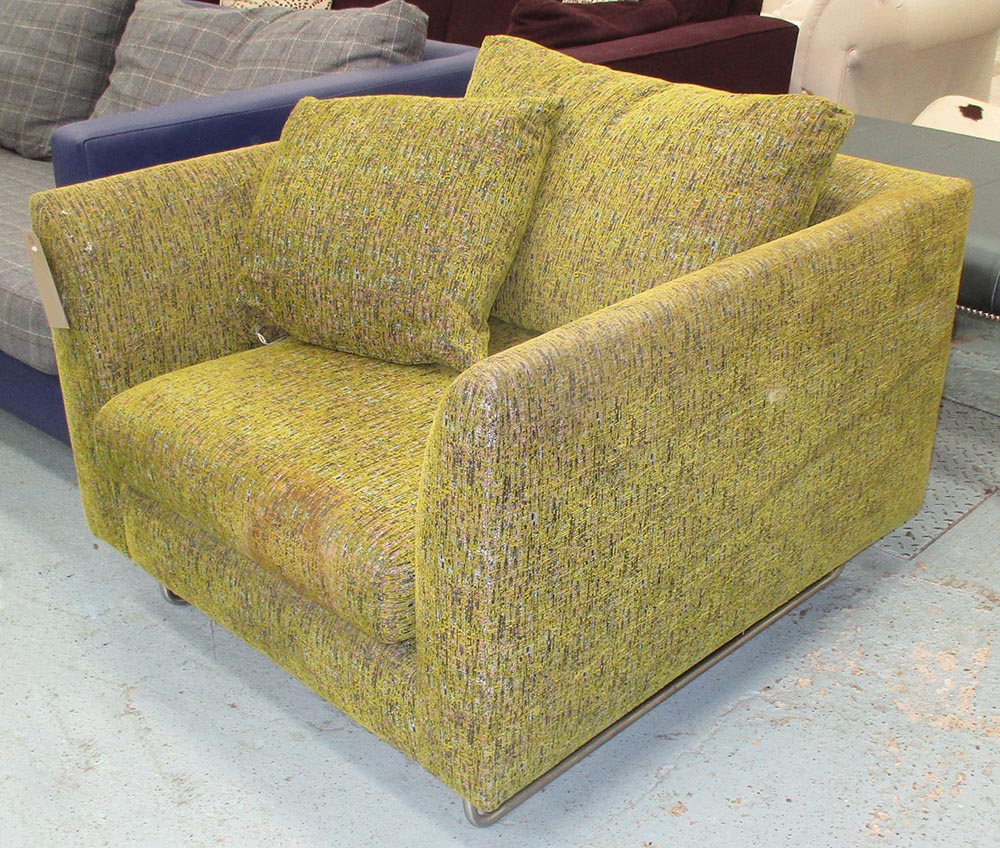 ARMCHAIR, contemporary in a green patterned fabric on metal supports,