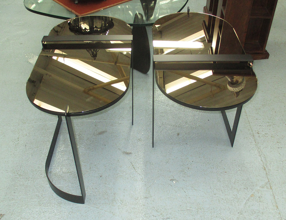 MIRRORED LOW TABLES, a pair, on black metal supports, 82cm x 40cm x 51cm H.