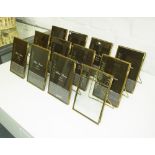 PHOTO FRAMES, a set of twelve, in gilded frames, 16cm x 10cm.