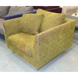 ARMCHAIR, contemporary in a green patterned fabric on metal supports,