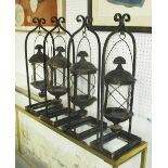 STORM LANTERNS, a set of four, circular in a black rustic metal frame, 64cm H.