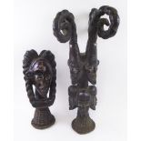 EKOI HEAD CARVINGS, two various examples, West African leather clad wood, basketwork bases,