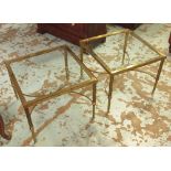 LOW OCCASIONAL TABLES, a pair, brass framed with a square glass top joined by wavy stretchers,