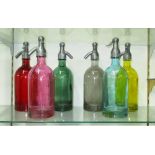 SODA SYPHONS, a set of six, in various colours, 32cm H.