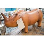 FOOTSTOOL, in the form of a rhinoceros in tanned leather, 59cm L.