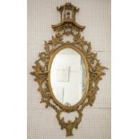 WALL MIRROR, 20th century Chippendale style giltwood with oval plate and ho ho birds to the sides,