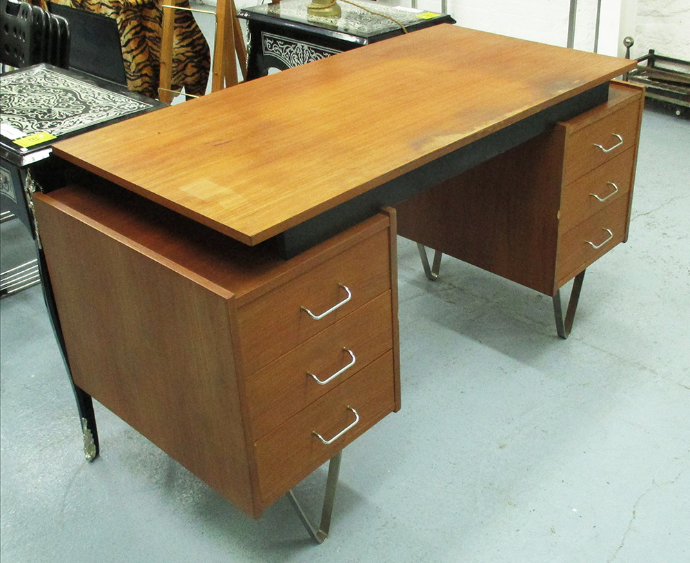 DESK IN THE MANNER OF CEES BRAAKMAN, with six drawers on metal supports, 142cm x 60cm x 76cm H.