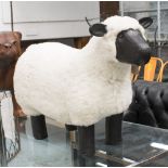 FOOTSTOOL, in the form of a sheep in black leather and wool, 75cm L.