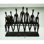 TABLE ORNAMENT, of a family seated on a bench, in bronzed resin, 39cm L.