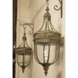 HANGING LANTERNS, a pair, a gilt metal with glazed panels of hexagonal form suspended from brackets,