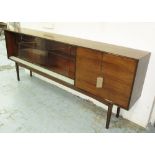 SIDE CABINET, 1970's walnut with two sliding glazed doors and two panelled doors,