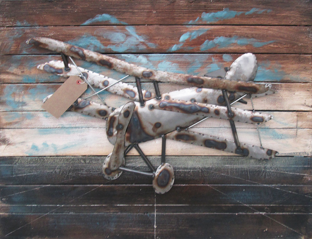 21ST CENTURY DECORATIVE METAL PANEL, of a triplane, on a wooden frame, 75cm x 100cm.