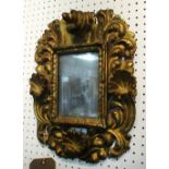 WALL MIRROR, 18th century Italian giltwood with distressed plate of compact proportions,