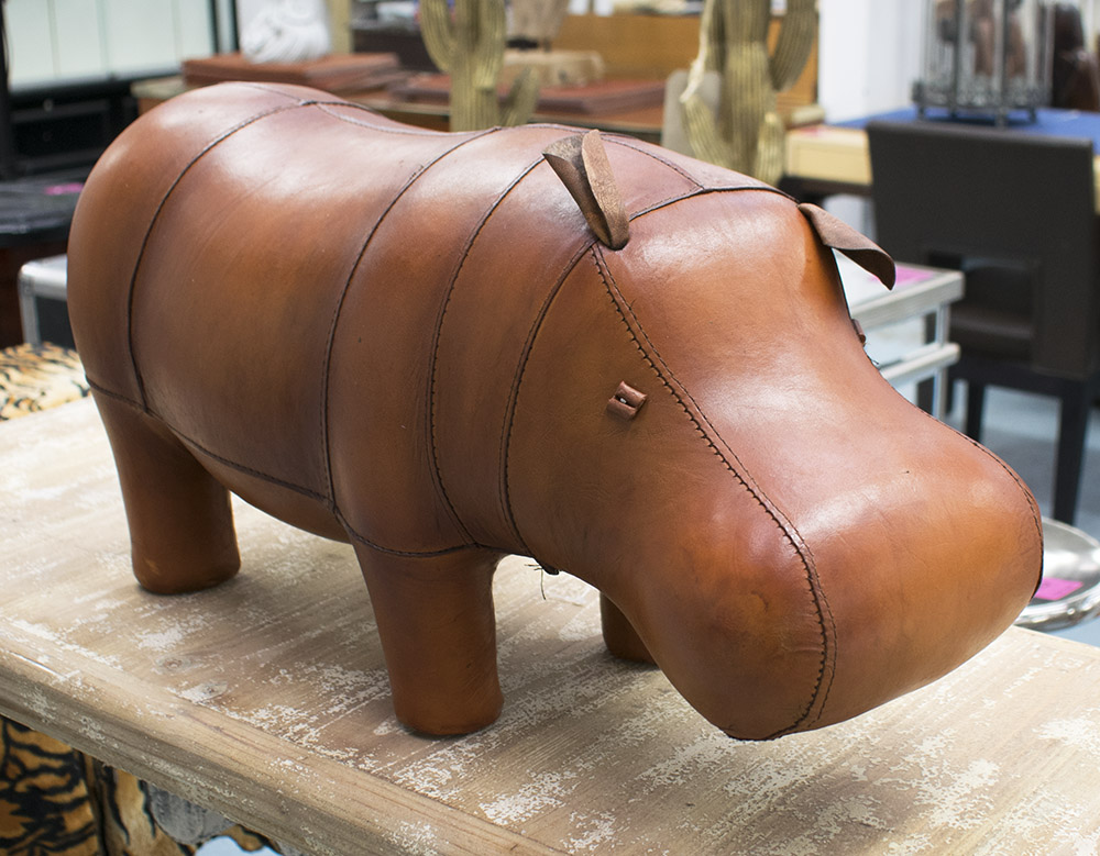 FOOTSTOOL, in the form of a hippopotamus in tanned leather, 59cm L.