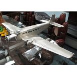 MODEL AIRCRAFT OF A JUNKERS JU-52, in aluminium cladding on a chromed metal stand,