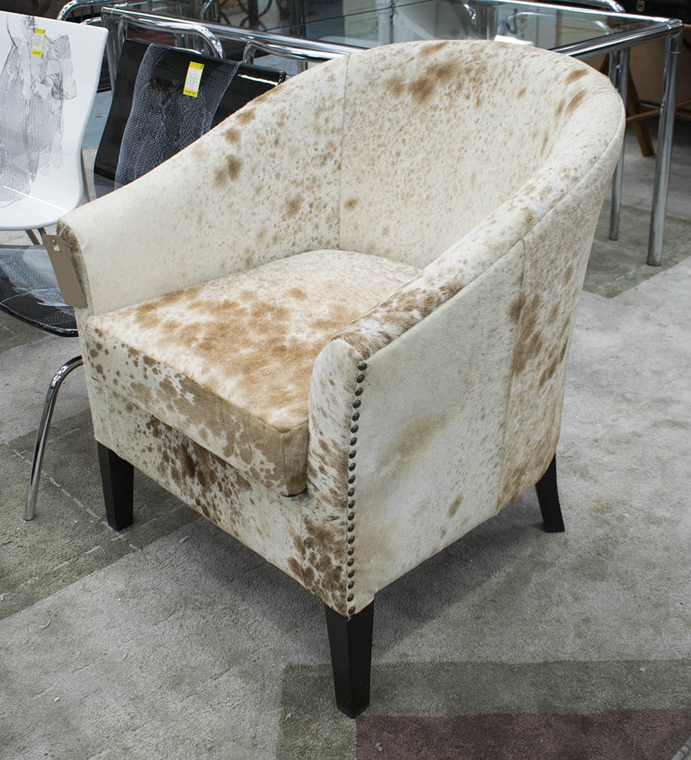 CLUB ARMCHAIR, in cowhide studded on square supports, 77cm W.