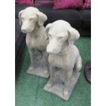 GARDEN DOG STATUES, a pair, 19th century Cotswold stone style weathered finish, 75cm H x 58cm L.