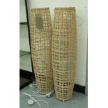 FLOOR LAMPS, a pair, curved form rattan with interior bulbs, 93cm H.