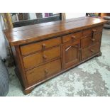 DRESSER BASE, Victorian pine with loose fruitwood slab top above a door and seven drawers,