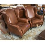 LAURA ASHLEY WING ARMCHAIRS, a pair, in a burnt sienna leather on turned supports,