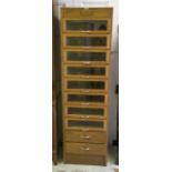 HABERDASHERY CABINET, mid 20th century oak, with eight glazed and two further drawers below,