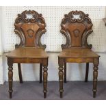 HALL CHAIRS, a pair, Victorian mahogany each with scroll and cartouche panel back.