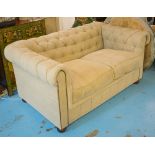 CHESTERFIELD SOFA, two seater, with a buttoned back and oatmeal upholstery on bun feet,