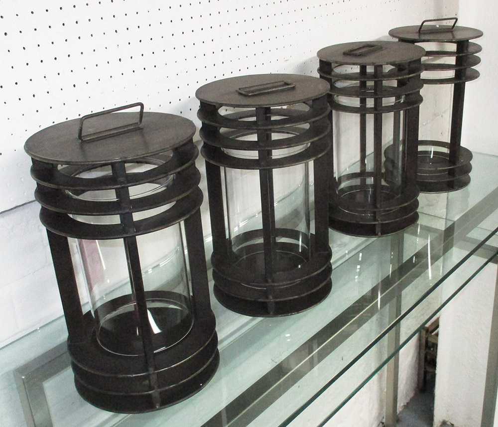 STORM LANTERNS, a set of four, circular in black metal finish, 31cm H.