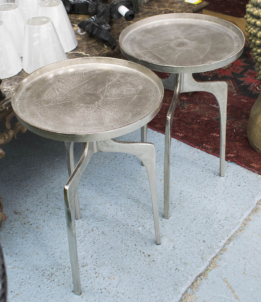 SIDE TABLES, a pair, circular in nickel on tripod supports, 41cm diam x 64cm H.