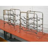 WINE RACKS, a pair, each for six bottles in chromed metal with leather straps, 50cm x 23cm x 46cm H.