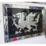 21ST CENTURY MIRRORED WELSH DRAGON, in the style of Damien Hurst in a mirrored frame.