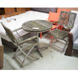 GARDEN TABLE, circular in weathered slatted wood 70cm diam x 74cm H plus a pair of matching chairs,