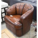 TUB ARMCHAIRS, a pair, hand finished stitched tan leather each on a rotating rocker support, 84cm W.