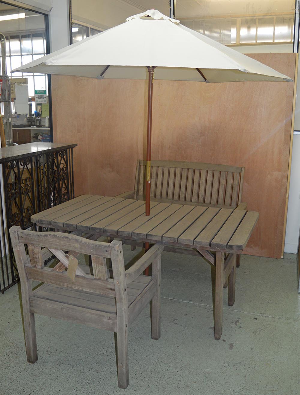 GARDEN FURNITURE, rectangular table weathered slatted with parasol, conforming armchair and a bench,