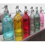 SODA SYPHONS, a set of six, in various colours, 31cm H.