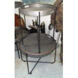 TRAY TABLES, a graduated pair, in metal with collapsable stands, smallest 60cm diam.