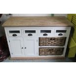 SIDEBOARD, cream painted with four drawers, cupboard and two wicker baskets below,