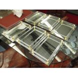 MIRRORED TRAYS, a set of six, with lucite galleries and brass effect mounts, 37cm x 25cm.