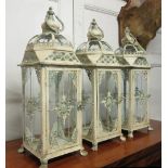 GARDEN LANTERNS, a set of three, distressed metal framed with a glazed top and side panels, 26.