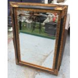 WALL MIRROR, with a black and gilt frame and bevelled plate, 81cm x 102cm.