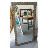 MIRRORS, a pair, with embossed frames in a burnished gold finish, 126cm x 63cm.