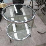 OCCASIONAL TABLE, circular with glass top and undershelf on chromed metal frame with castors,