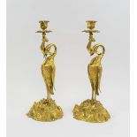 A PAIR OF GILT METAL STORK CANDLESTICKS, each bird with fish in beak supporting a sconce, 37.