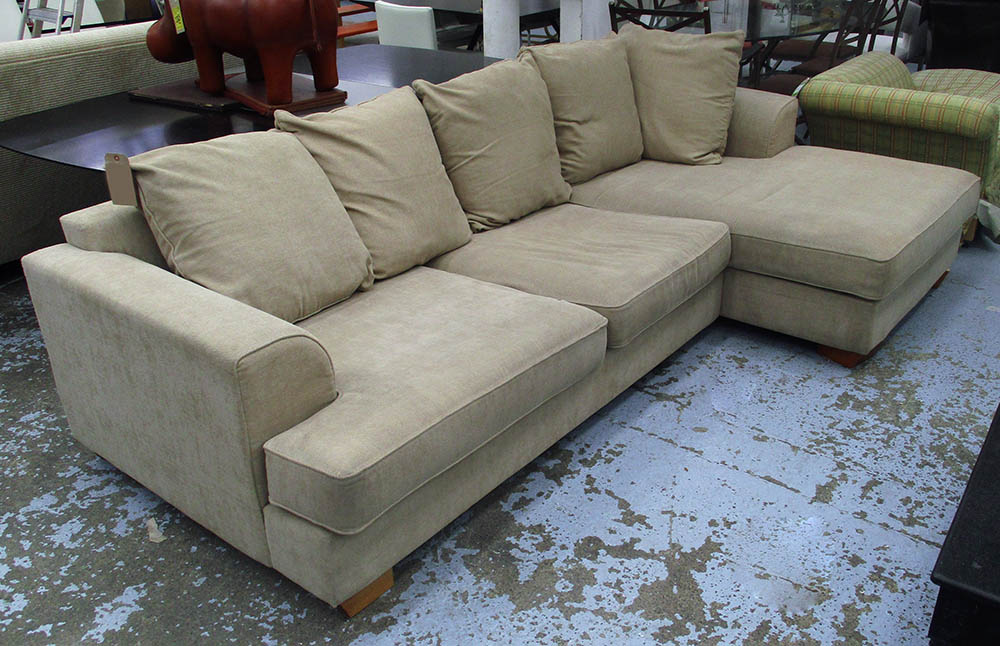 CORNER SOFA, in beige fabric on block supports, plus five cushions to match, 278cm x 163cm.